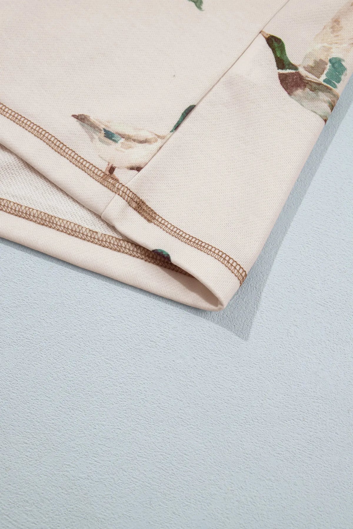 Khaki mallard print set stitched hem edge, detail view · nz-alt-v1