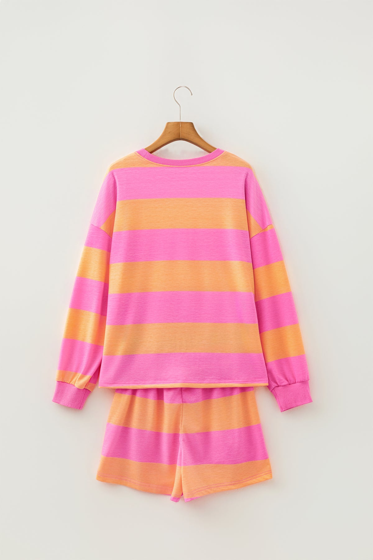 Pink stripe long sleeve top and drawstring shorts set hanging view from another angle