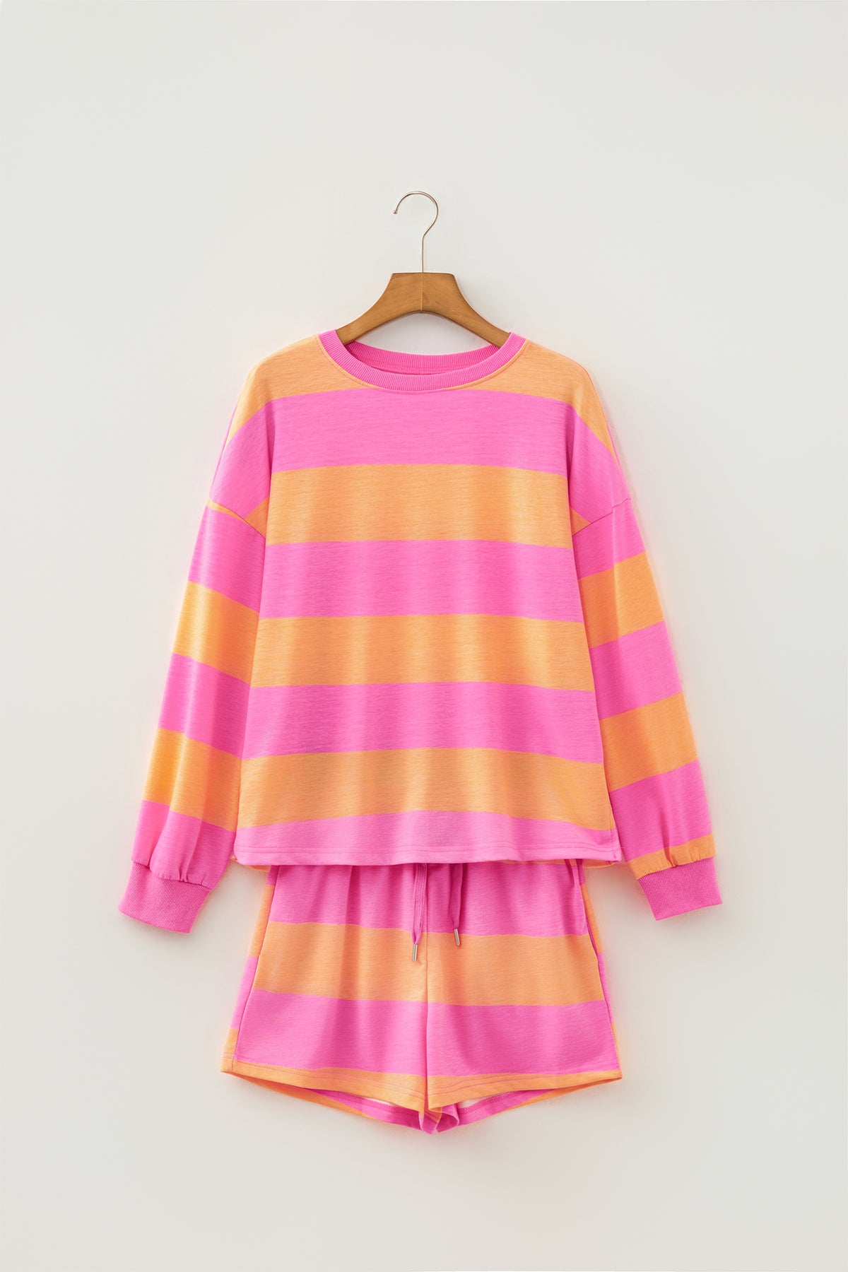 Pink stripe long sleeve top and drawstring shorts set hanging view