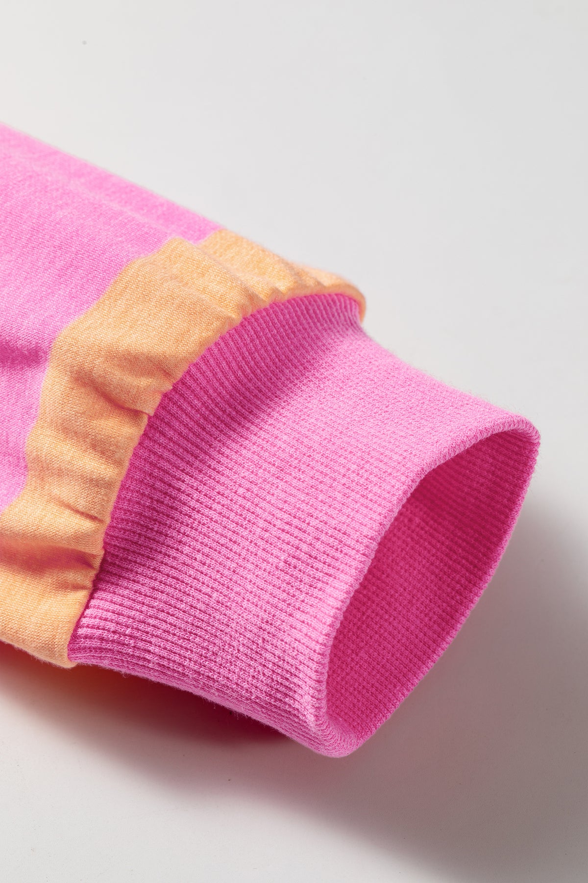 Pink stripe long sleeve top detail view of ribbed cuff