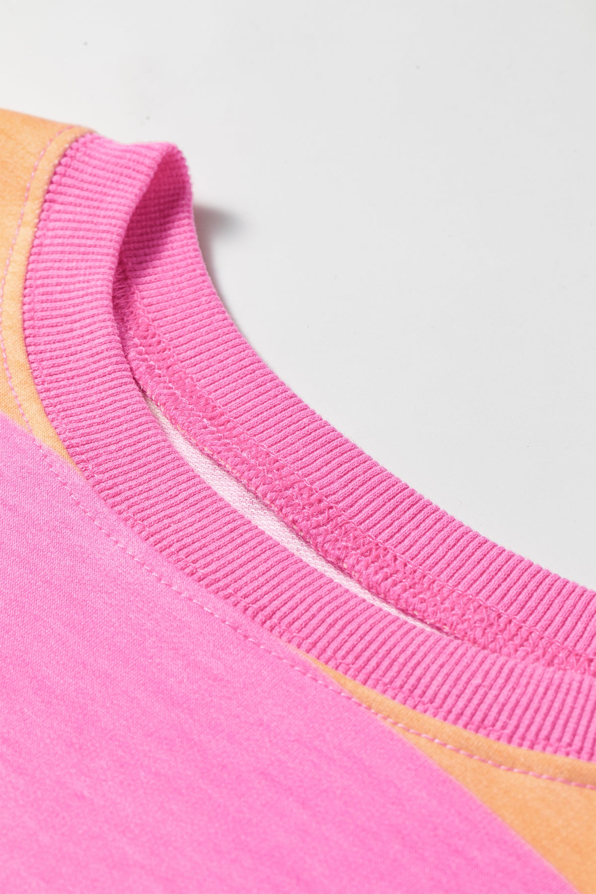 Pink stripe long sleeve top detail view of ribbed neckline