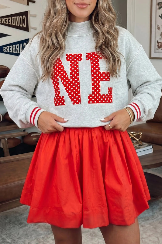 Fiery Red U Neck Long Sleeve Fit and Flare Short Dress styled with sweatshirt model front view · nz-alt-v1