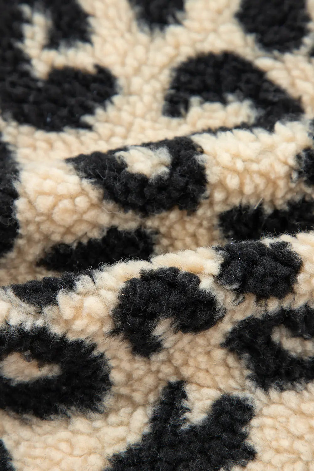 Cream leopard print sherpa fabric close-up, detail view · nz-alt-v1