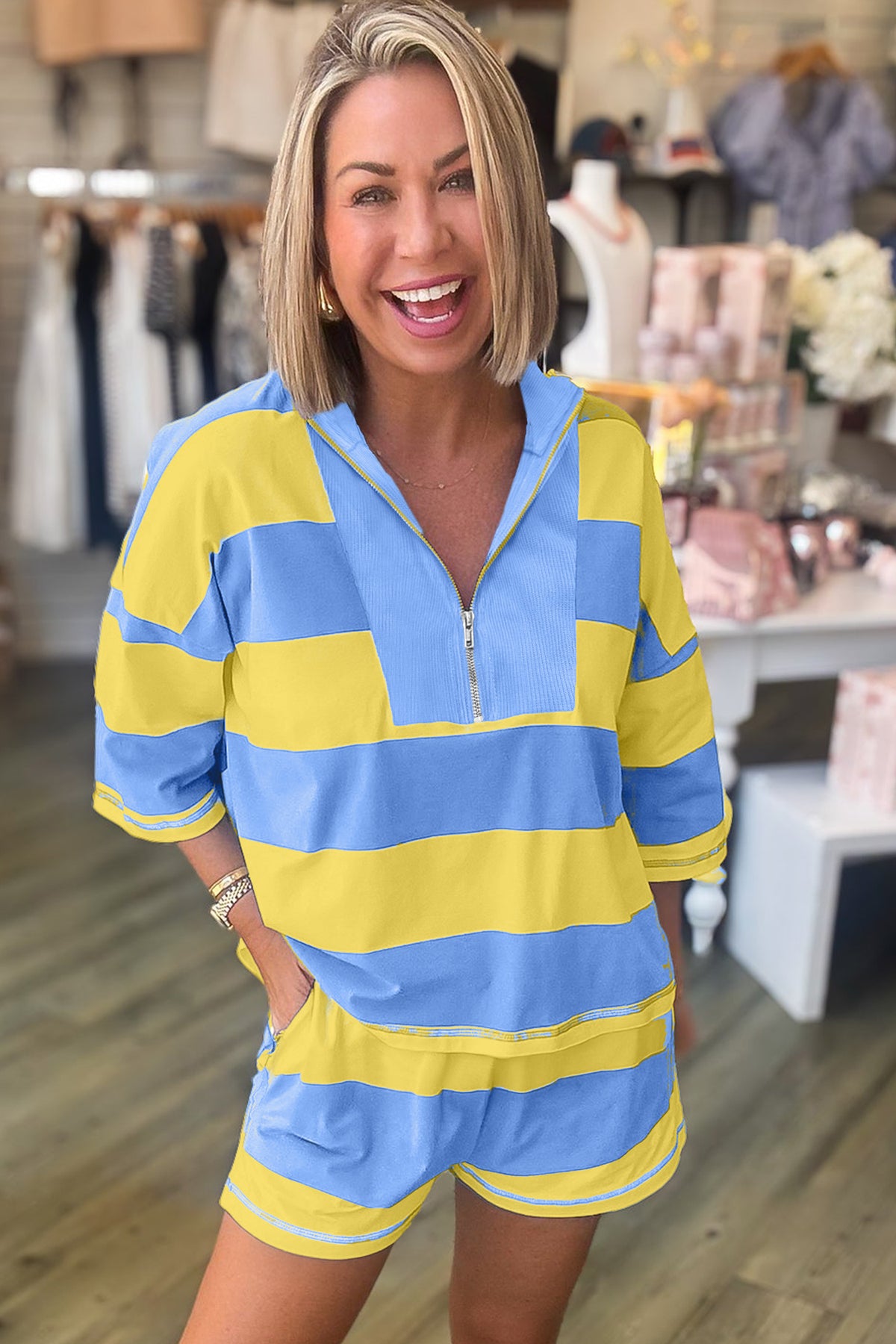 Yellow stripe half zip top and casual shorts set model front view in showroom