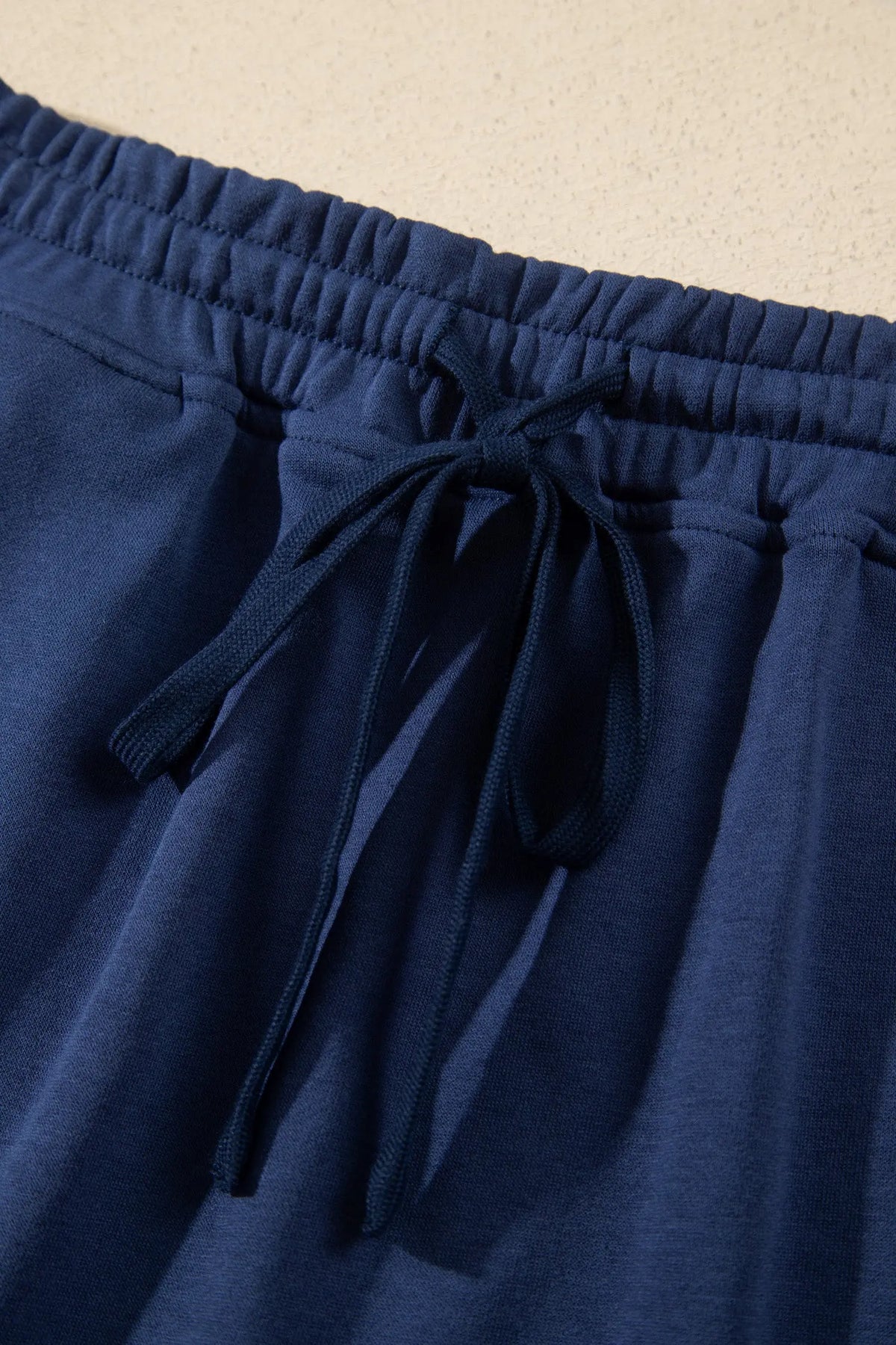 Navy blue long sleeve zip-up top elastic waist skort set detail view · nz-alt-v1