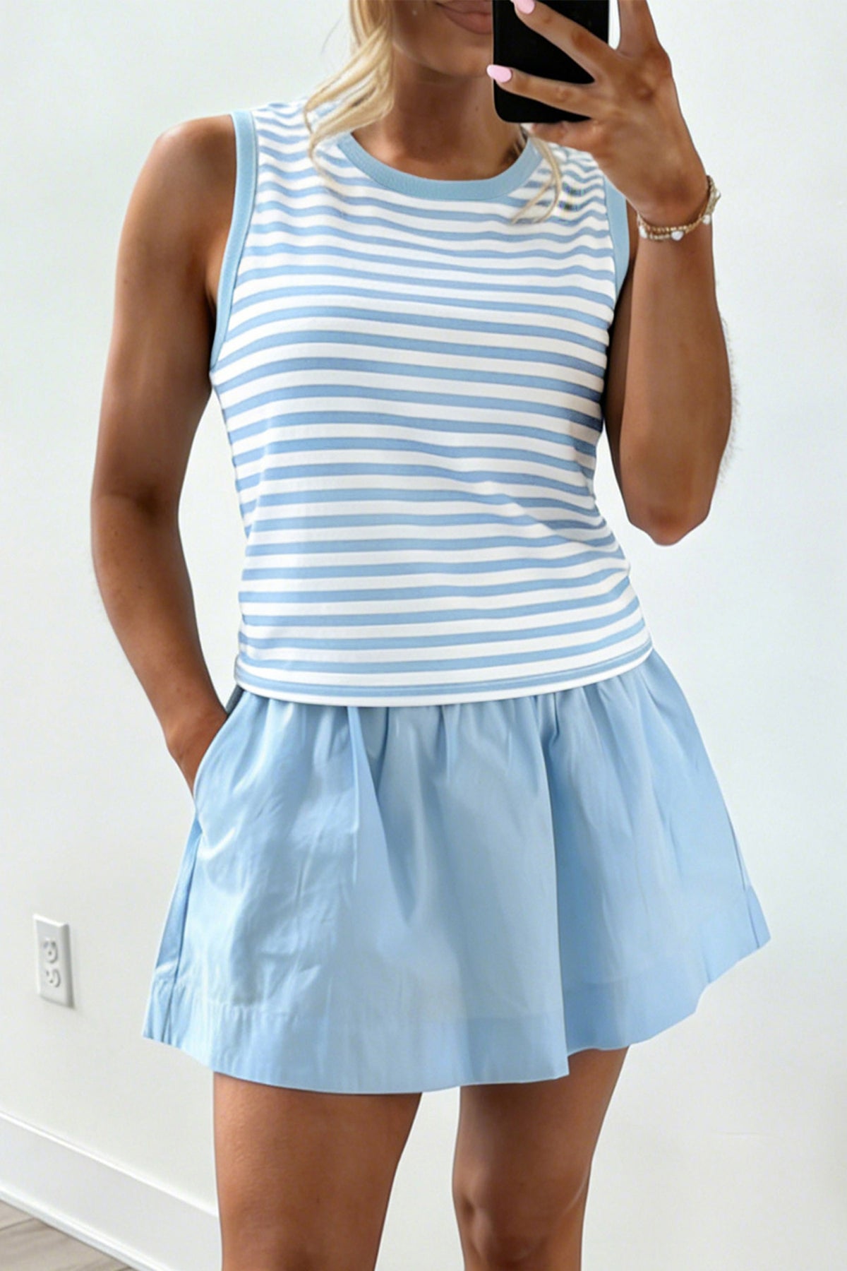Sky blue stripe slim tank and ruffle mini skort set model front view with hands in pockets