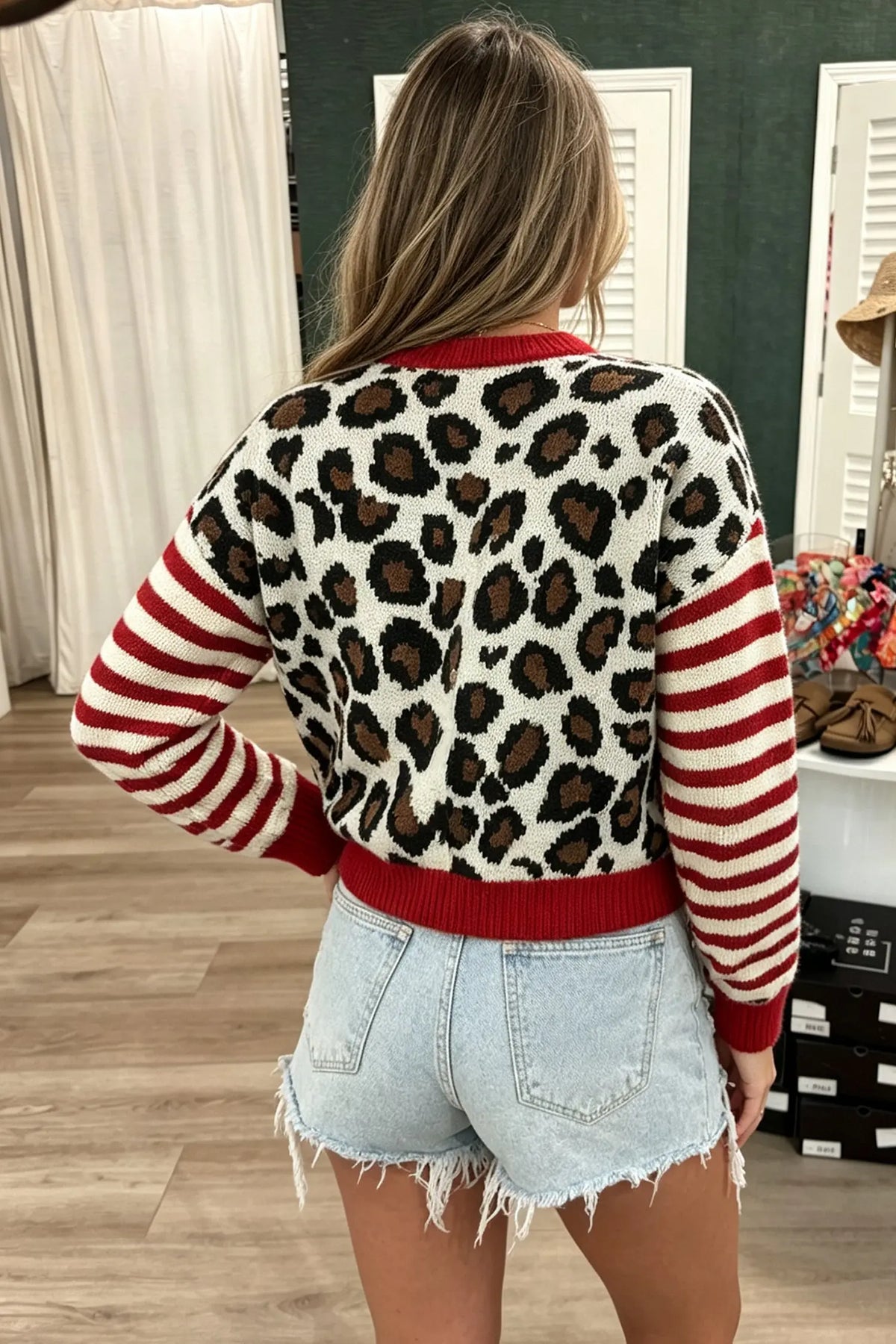 Leopard print cropped cardigan with red striped sleeves, model back view · nz-alt-v1