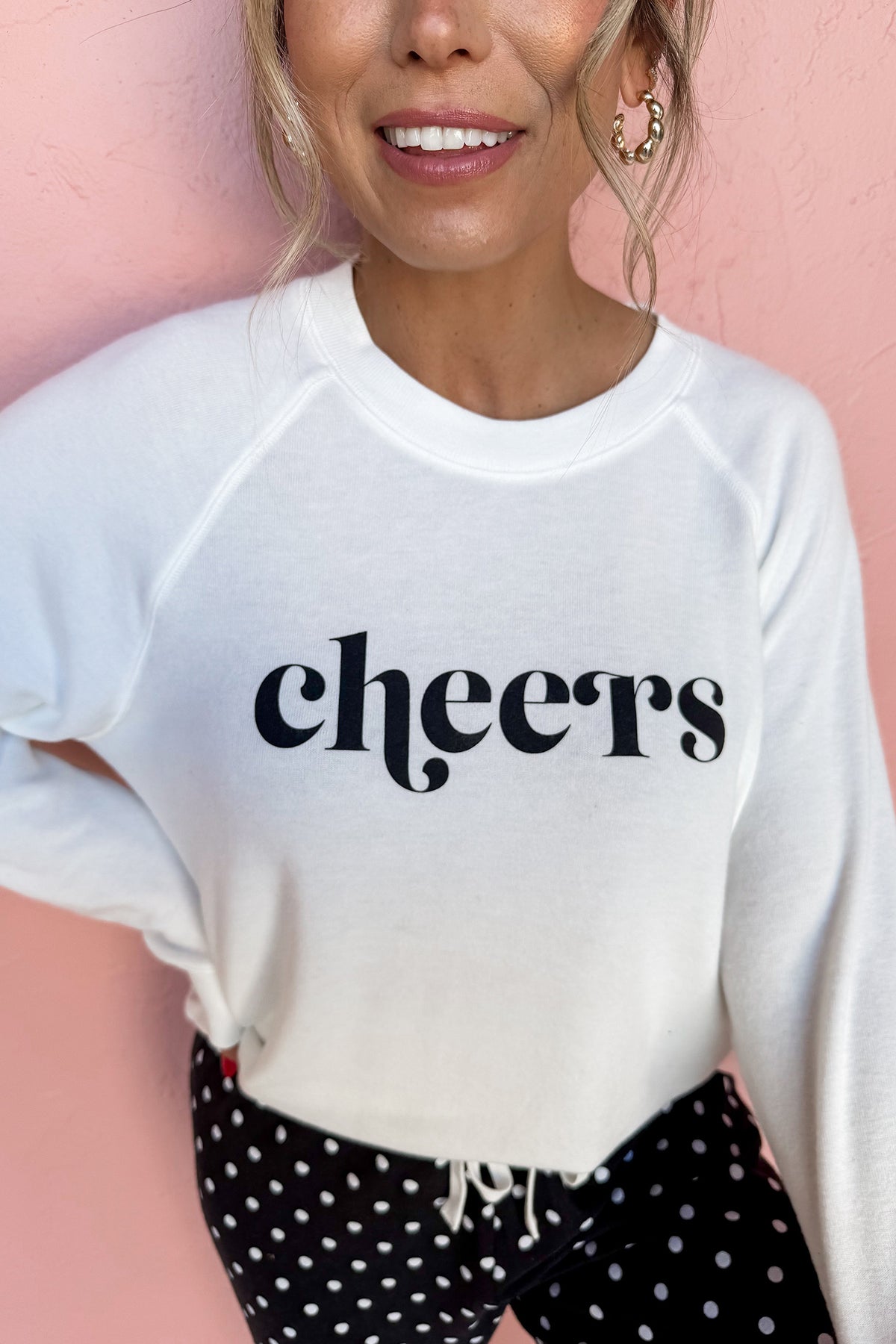 Black cheers graphic raglan pullover and polka dot pants loungewear set, detail view of cheers print · nz-alt-v1