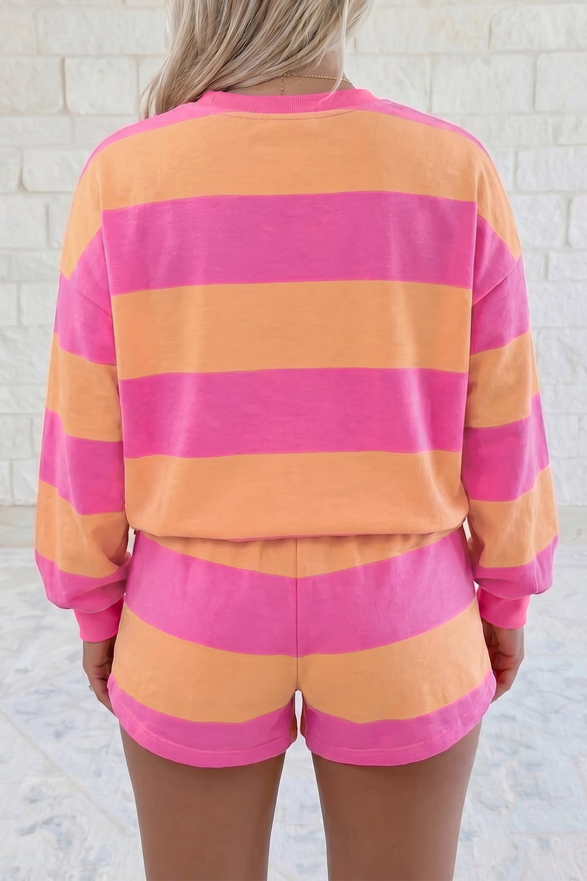 Pink stripe long sleeve top and drawstring shorts set model back view