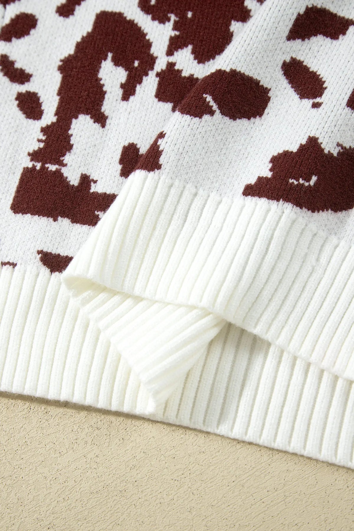 Brown cow print long sleeve pullover knit sweater detail view · nz-alt-v1