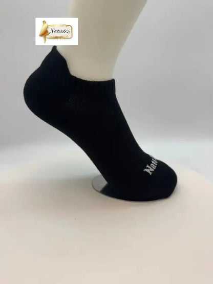 Black ankle sock on a mannequin foot against a white background