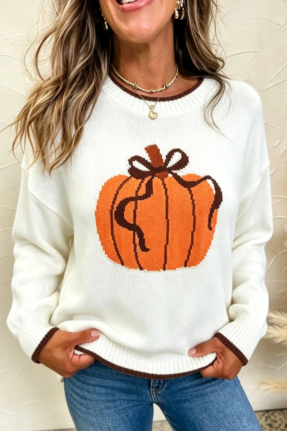 Cream fall pumpkin pattern casual pullover sweater with brown trim model front view · nz-alt-v1