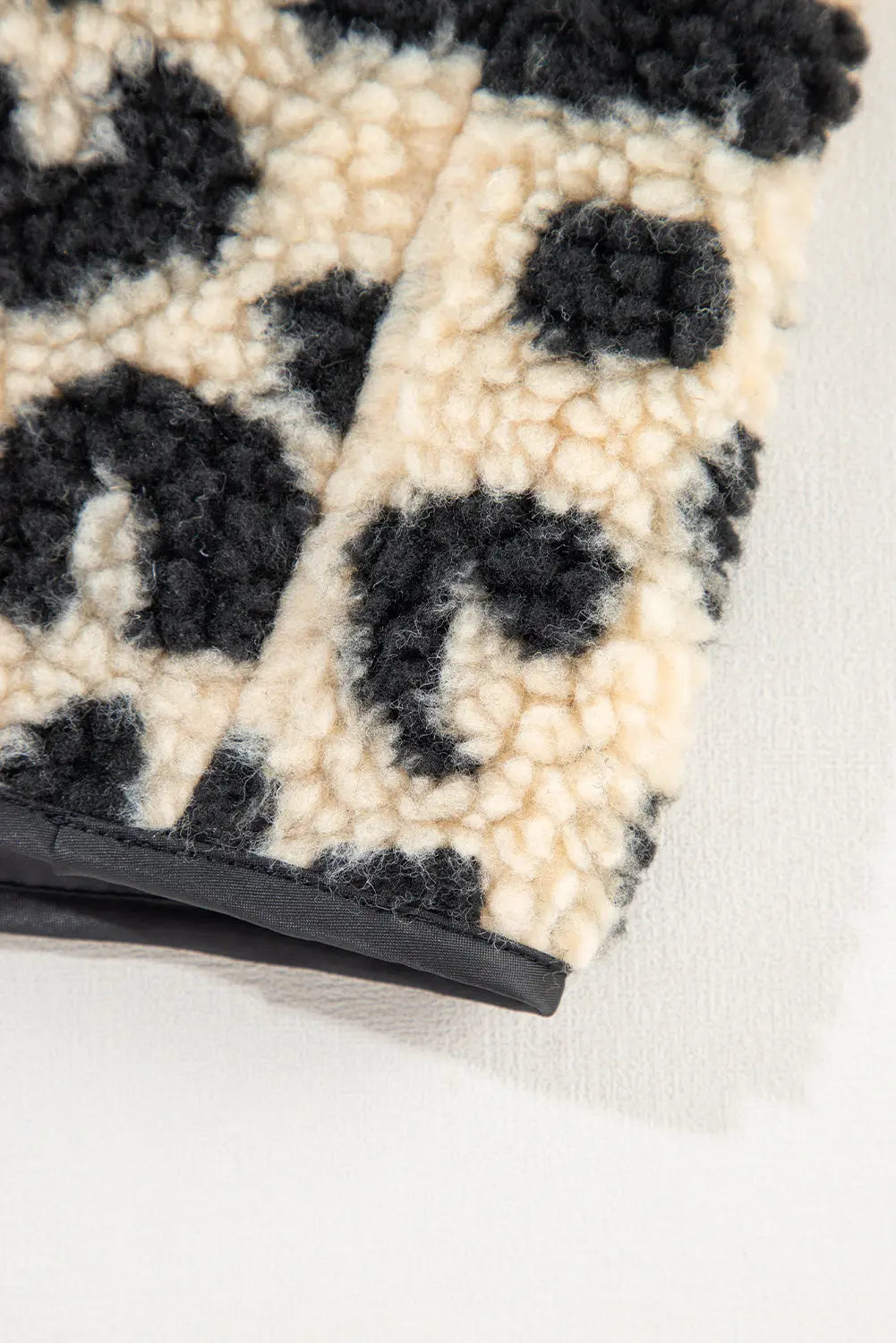 Cream leopard print sherpa vest coat hem corner, detail view · nz-alt-v1