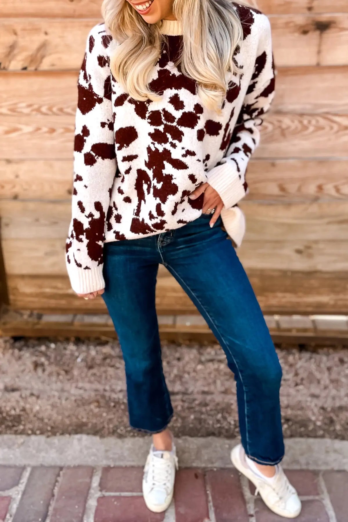 Brown cow print long sleeve pullover knit sweater model front view · nz-alt-v1