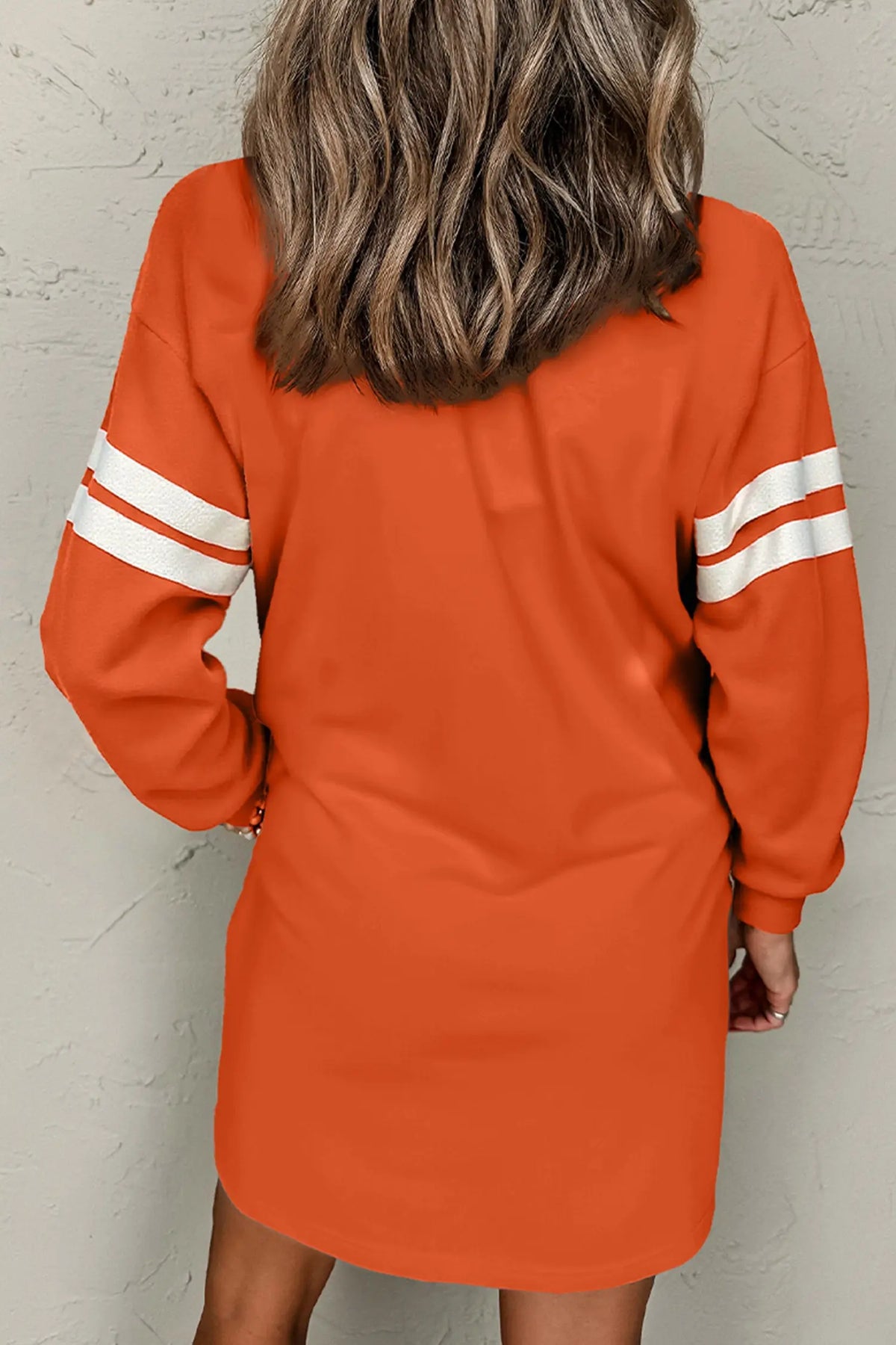 Orange sequin ghost varsity sleeve sweatshirt mini dress model back view · nz-alt-v1