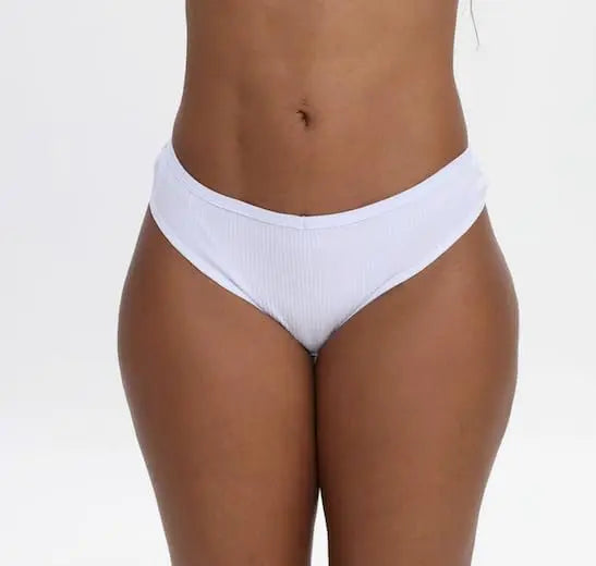 Nataliz stretch cotton thong front view, model holding waistband