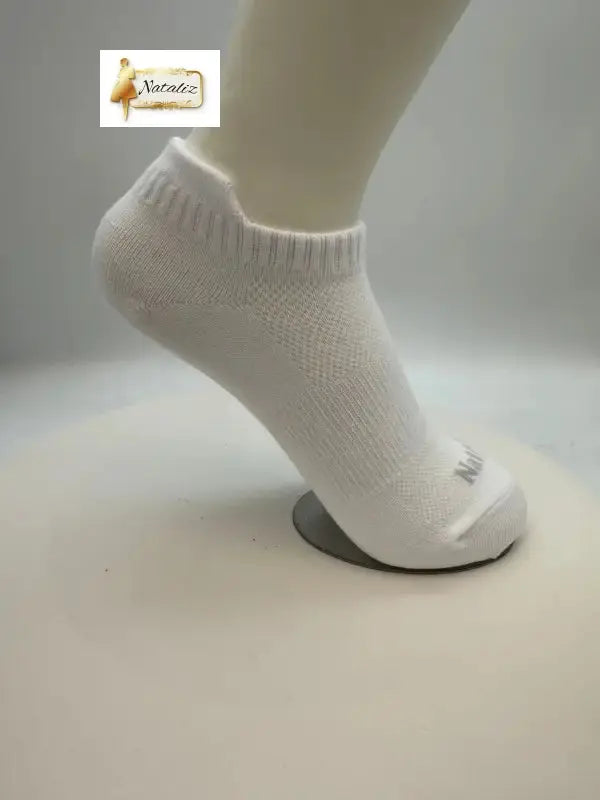 White ankle sock on a mannequin foot against a plain background
