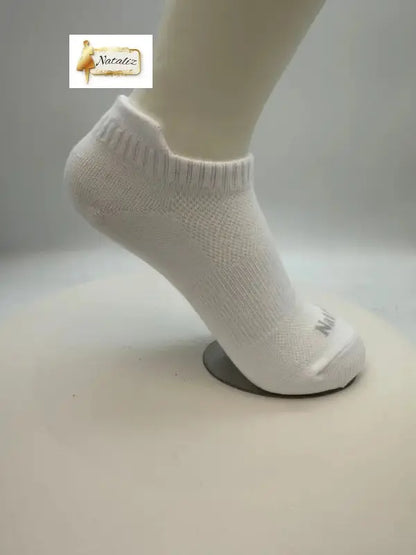 White ankle sock on a mannequin foot against a plain background